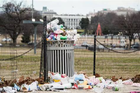 The White House Can Be Seen Behind An Overflowing Trash Can Business
