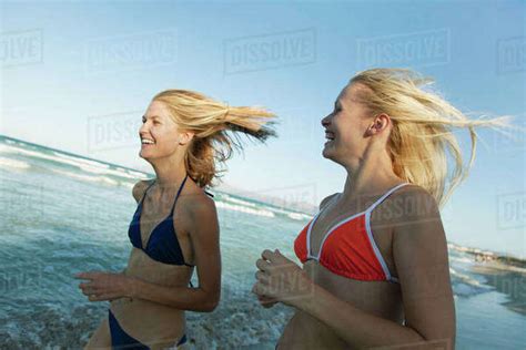 Women Jogging At The Beach Stock Photo Dissolve