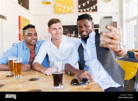 Friends Taking Selfie And Drinking Beer At Bar Stock Photo Alamy