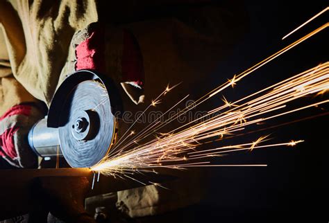 Worker Cutting Metal With Grinder Sparks While Grinding Iron Stock