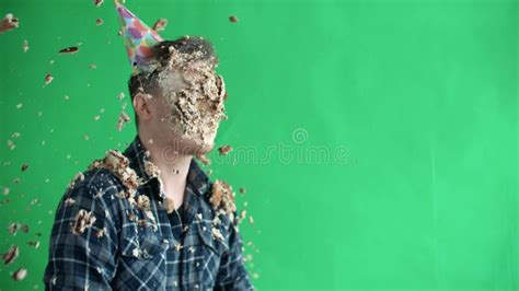 a cake is thrown at a man a manand x27 s face smeared with cake cream birthday stock image