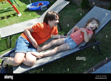 Tickle Time A Brother And His Two Sisters Spend Time Together In The Sunny Outdoors And Have