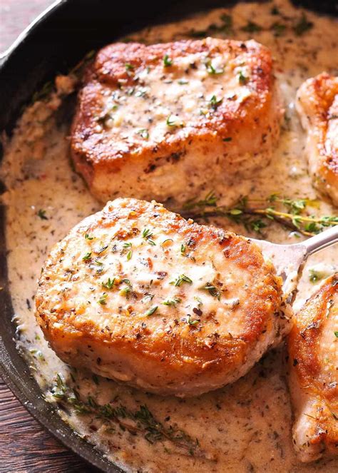 Boneless Pork Chops In Creamy White Wine Sauce Are Cooked In The Juice