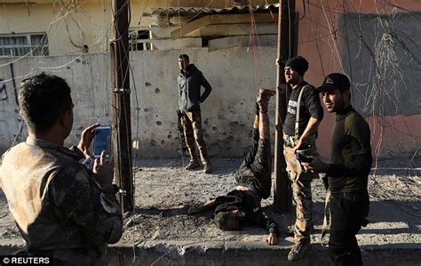 Iraqi Special Forces Soldiers Pose Next To Body Of An Isis Fighter In