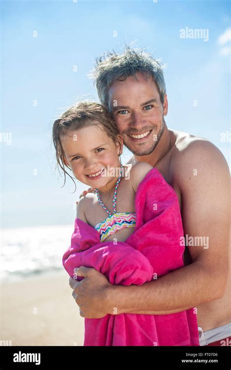 Daddy At The Beach Wrapping His Little Girl In A Towel After Bath Stock