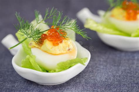 Staffed Egg Appetizer With Red Caviar Garnish And Dill Decoratio Stock