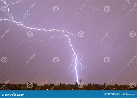 Lightning Streak From A Thunderstorm Cloud At Night In A Rural Setting