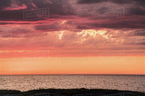 View Of Sea Against Cloudy Sky During Sunset Stock Photo Dissolve