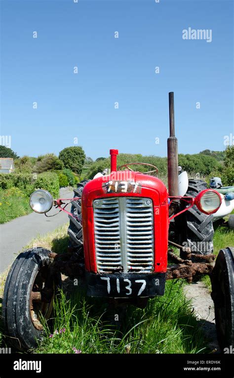 Old Red Tractor Parked In A Lane In Guernsey Stock Photo Alamy