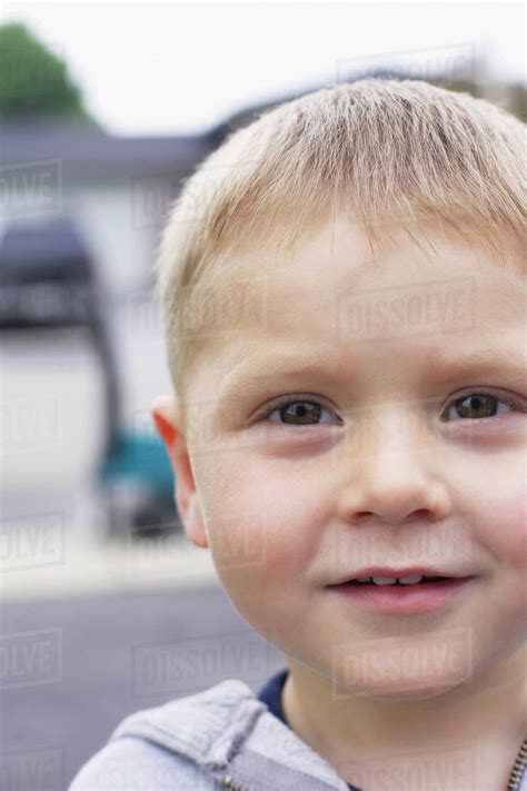 Head Shot Of Young Boy Outdoors Stock Photo Dissolve