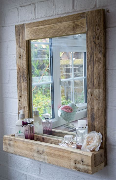 A lovely simple rustic bathroom set up here, with a very basic wooden vanity comfortably bearing a farmhouse sink. Rustic Bathroom Mirror made from reclaimed pallet wood