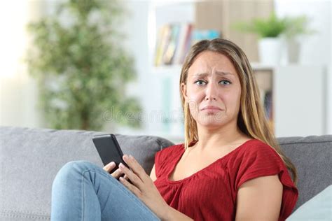 frustrated woman holding a phone on christmas at home stock image image of christmas bored