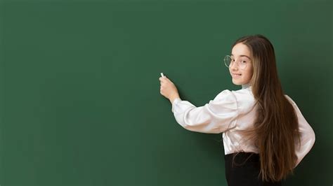 Premium Photo Adorable Girl Writing On Blackboard