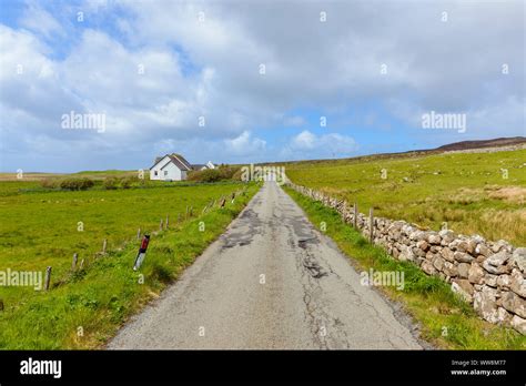 Typical Scottish Single Track Road In Countryside And Lonely House