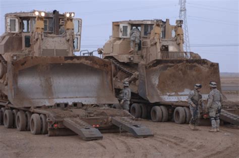 Us Army Soldiers Prepare To Unload Two Armored Caterpillar D9 Bulldozers