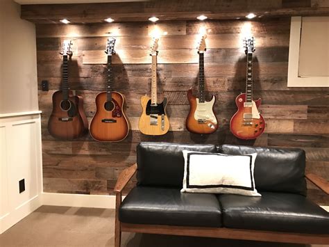 Guitars Are Hanging On The Wall Behind A Leather Chair