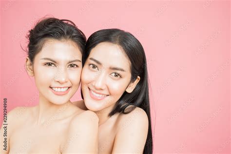 Closeup Portrait Of Two Young Beautiful Sexy Asian Woman Isolated On