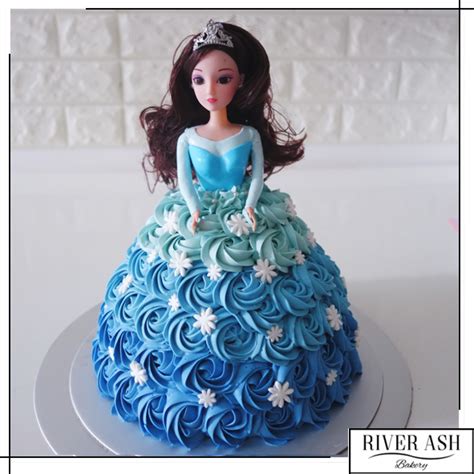 The classic princess cake will never tire out so here's my version of it decorated with forked buttercream, piped buttercream, rolled modeling chocolate, piped chocolate, and a doll pick. 3D Princess Doll Cake Singapore - River Ash Bakery