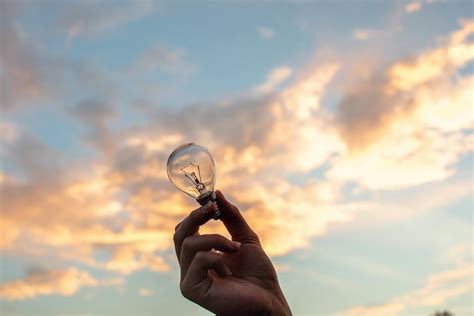 Person Holding Clear Light Bulb · Free Stock Photo