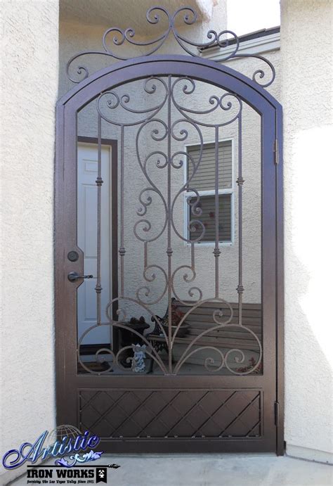 An Iron Gate Is Open On The Side Of A House With A Cat Sitting In It