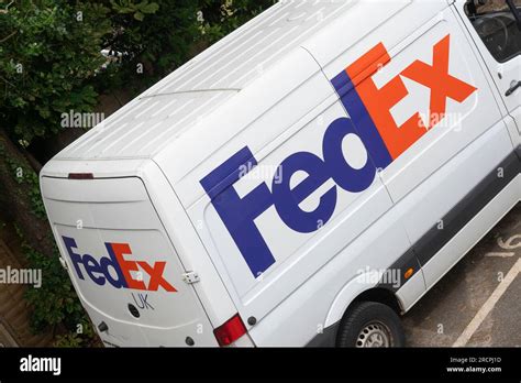 FedEx white delivery van with FedEx logo and livery parked in front of
