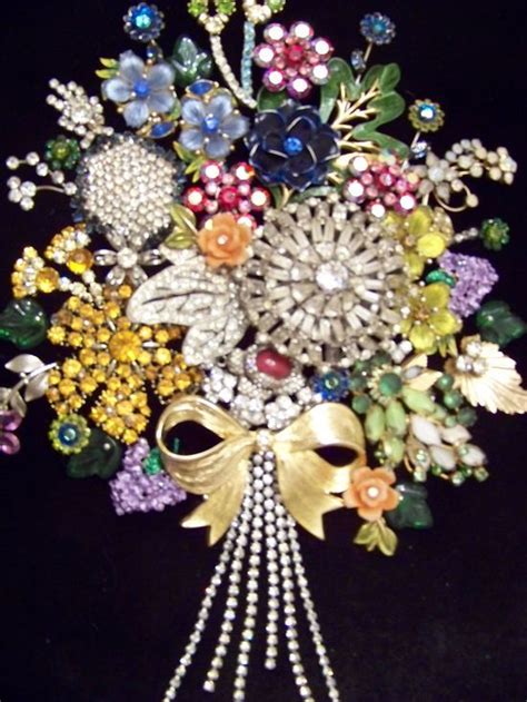 Old Jewelry Made To Look Like A Bouquet Of Flowers To Hang On A Wall