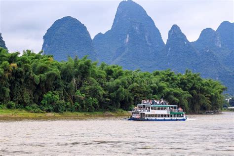 A Pleasure Boat Is Floating Along The Li River Known As Well As Lijiang