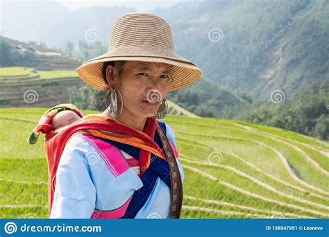 Sapa, Vietnam - May 2019: Hmong Woman In Traditional Dress Walks Along ...