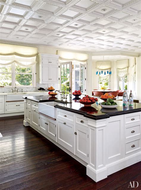 Interior of modern kitchen with white brick walls, dark blue traditional kitchen with pot hanger. White Kitchen Cabinets Ideas and Inspiration Photos ...