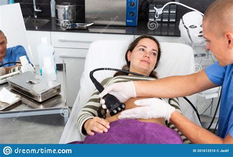 Cosmetologist Performing Ultrasound Cavitation Body Procedure For