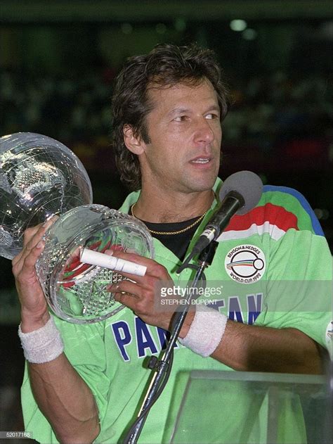 Pakistans Captain Imran Khan Holds The 1992 World Cup Trophy During