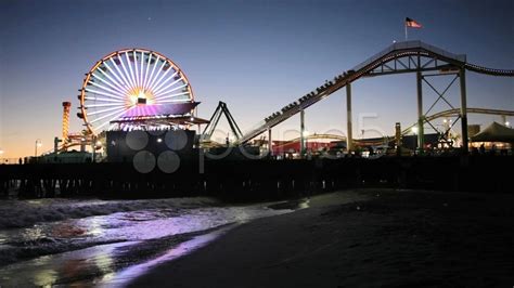 Santa Monica Pier Amusement Park At Night And Pacific Ocean In