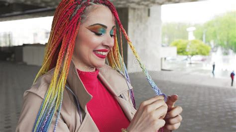 Fashionable Girl In A Jacket Straightens Her Colored African Braids