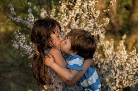 Premium Photo Siblings Hugging Kissing In Spring Evening Forest Little Cute Caucasian Girl