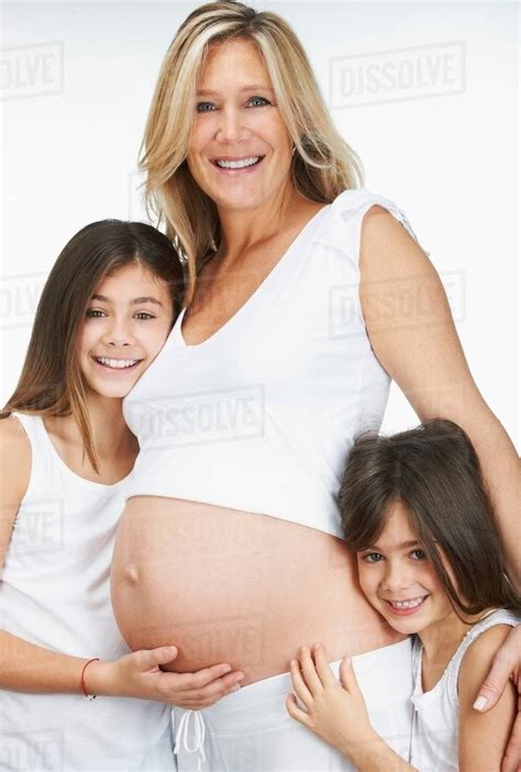 Pregnant Mother Hugging Daughters Stock Photo Dissolve