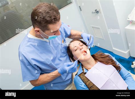 Dentist Performing Teeth Treatment With Female Patient Open Mouth With Tools Stock Photo Alamy