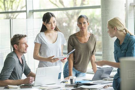 Office Workers Collaborating On Group Project Stock Photo Dissolve