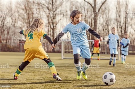 Two Female Girl Soccer Teams Playing A Football Training Match In The