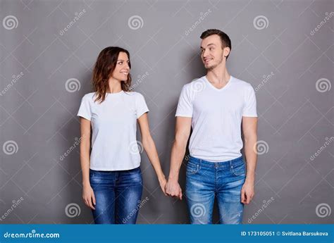 Romantic Couple Holds Hands And Look In Love At Each Other Stock Image