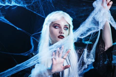 Halloween Witch With Long White Hair Wearing Spider Web Stock Photo