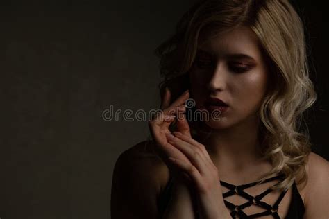 Blonde Girl With Glowing Skin And Naked Shoulders Posing With Contrast Light Space For Text