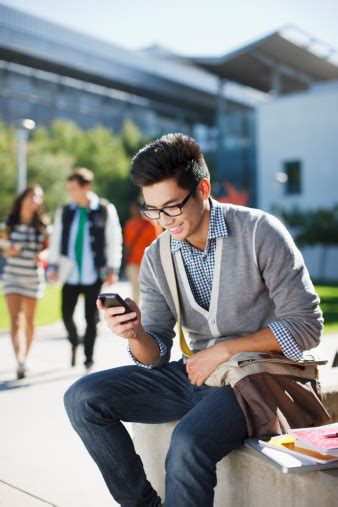 Smiling Student Using Cell Phone Outdoors Stock Photo - Download Image Now - iStock