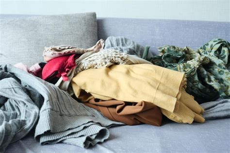 Premium Photo Messy Clothes On Sofa At Home