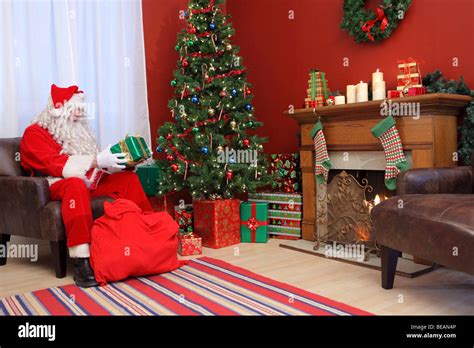 Santa Claus Putting Gifts Under Christmas Tree Stock Photo Alamy