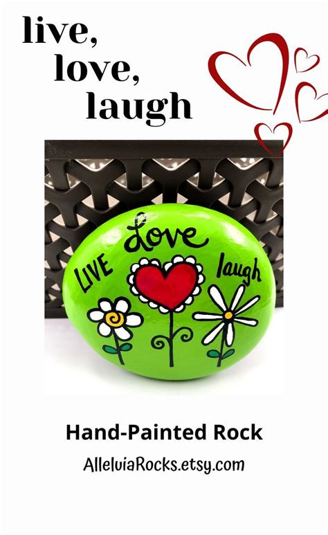 A Green Rock With The Words Live Love Laugh And Flowers Painted On It