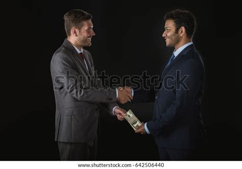 Businessman Giving Money Bribing Business Partner Stock Photo 642506440