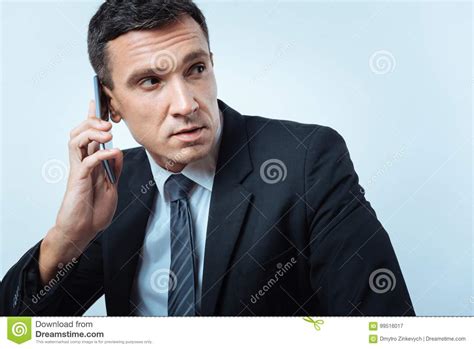 Serious Handsome Businessman Having A Phone Conversation Stock Image