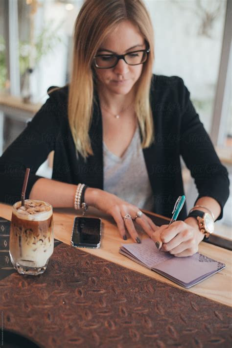 Woman Writing Her Diary In A Coffee Shop By Stocksy Contributor Jovo Jovanovic Stocksy