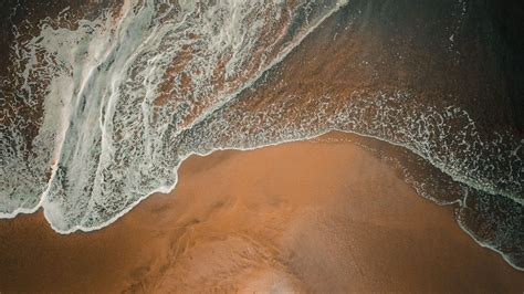 Download Wallpaper 1600x900 Beach Wave Aerial View Sand Widescreen