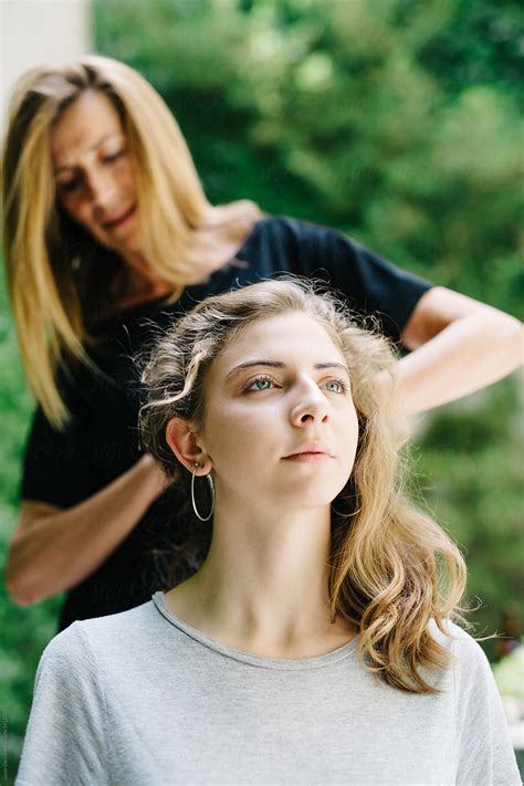 woman setting girl s hair by stocksy contributor javier díez stocksy
